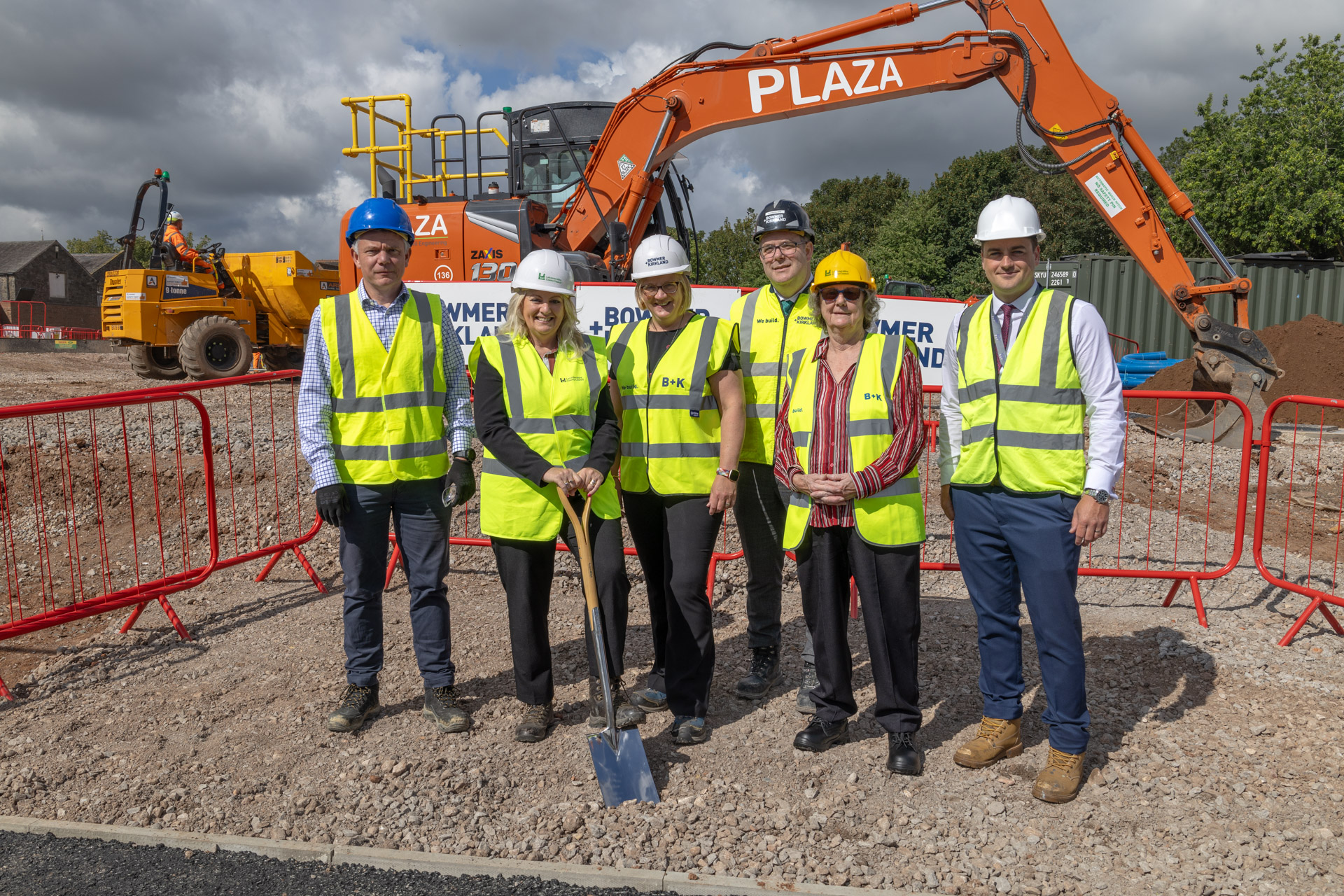 LA members, along with CIT and Bowmer&Kirkland, standing with a spade