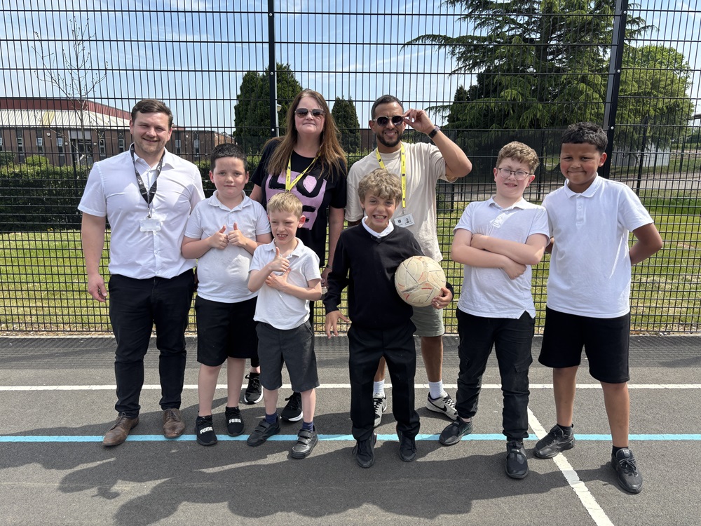 Headteacher and pupils cheer with Radio Breakfast show presenters