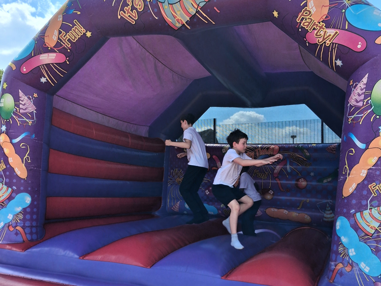 children jumping on a bouncy castle